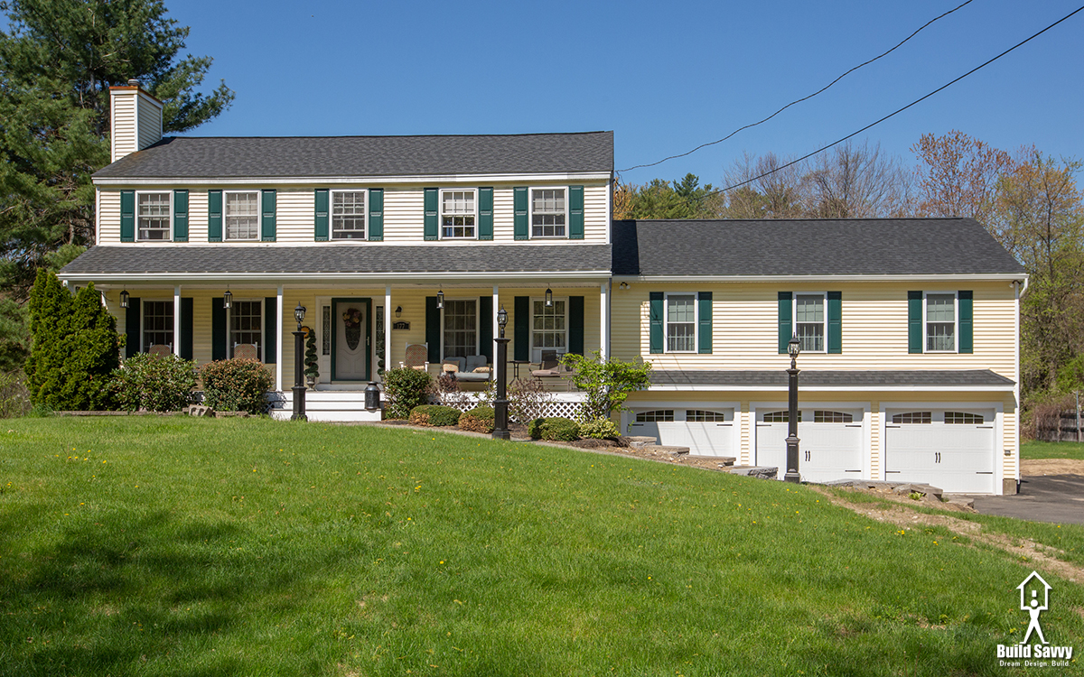 Outside of a yellow home with green shutters