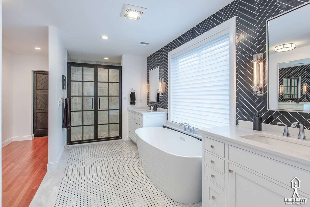 Walk in bathroom with black herringbone tile