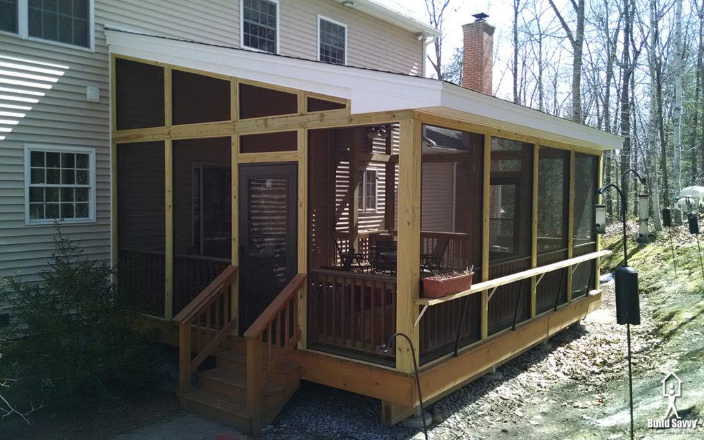 A screened in deck with roof overhang